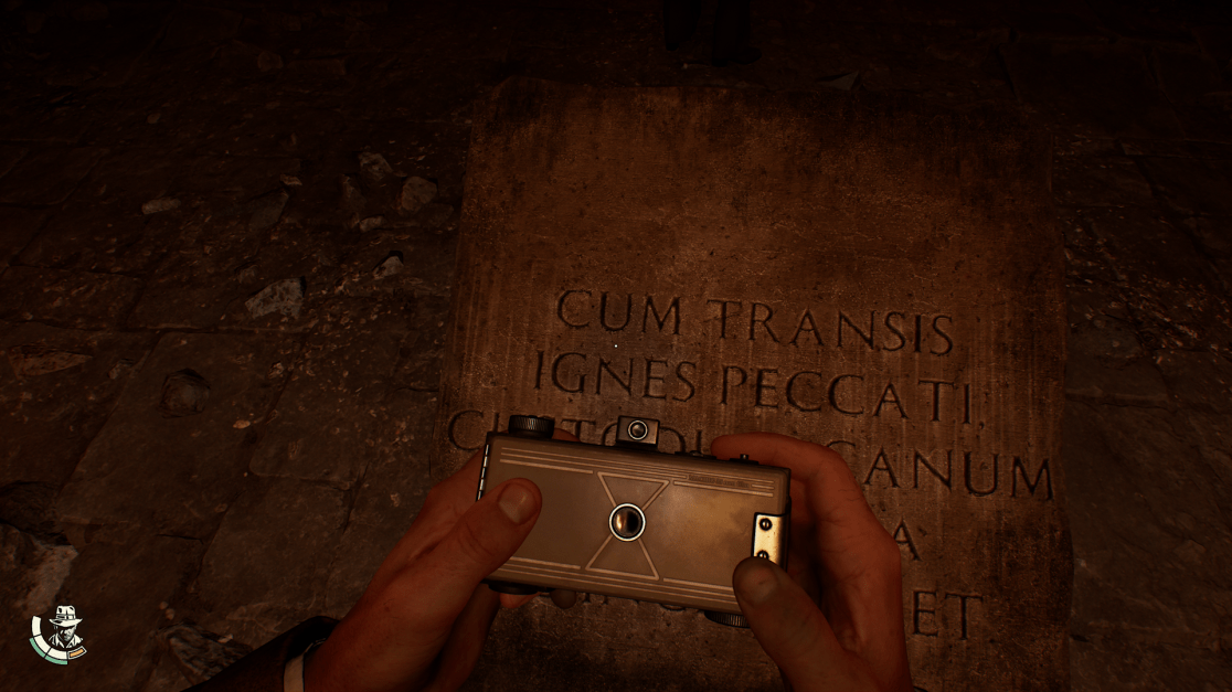 indy holding a camera to a plaque writing in Latin
