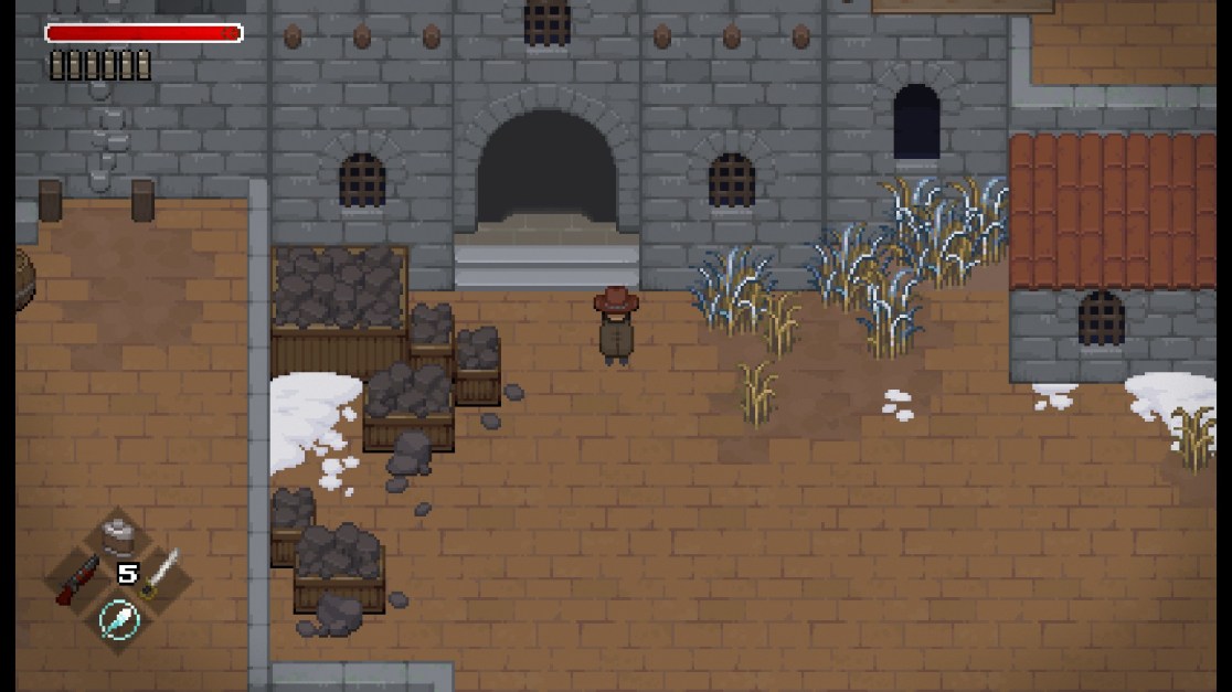The top-down view shows a character wearing a wide-brimmed brown hat and simple brown clothing, facing towards a large, austere gray stone building entrance. The building features a arched entrance and barred windows. The ground is made of brown brick. Wooden crates filled with dark-colored rocks sit on the left. Patches of snow are scattered throughout. On the left, UI elements indicate health, currency, and weapon details. A red health bar is at the top.