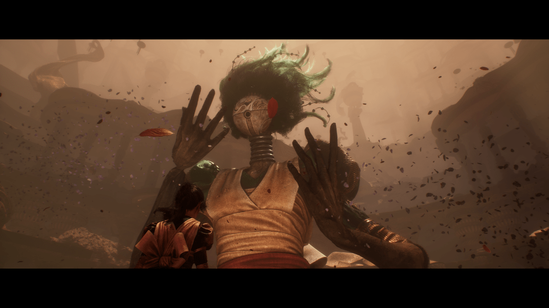 A young woman with dark hair and a brown and gold outfit stands looking up at a towering, mysterious entity. The entity has a mask-like face, a coiled neck, and green, leafy hair. Its large hands are raised, and leaves and petals swirl around them. The entire scene is bathed in a warm, dusty light, with rocky, abstract forms in the background, evoking a dreamlike or surreal atmosphere.