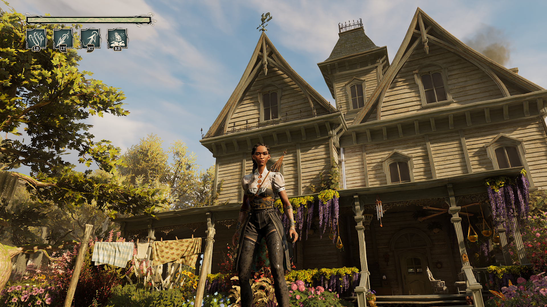 Gameplay screenshot from South of Midnight featuring a player character
standing in front of a large, Victorian-style house surrounded by lush trees, colorful flowers, and hanging laundry. The detailed environment highlights the game’s Southern Gothic aesthetic. On-screen UI elements display ability controls (LB, LT, RT, RB), emphasizing action-adventure mechanics and immersive exploration.