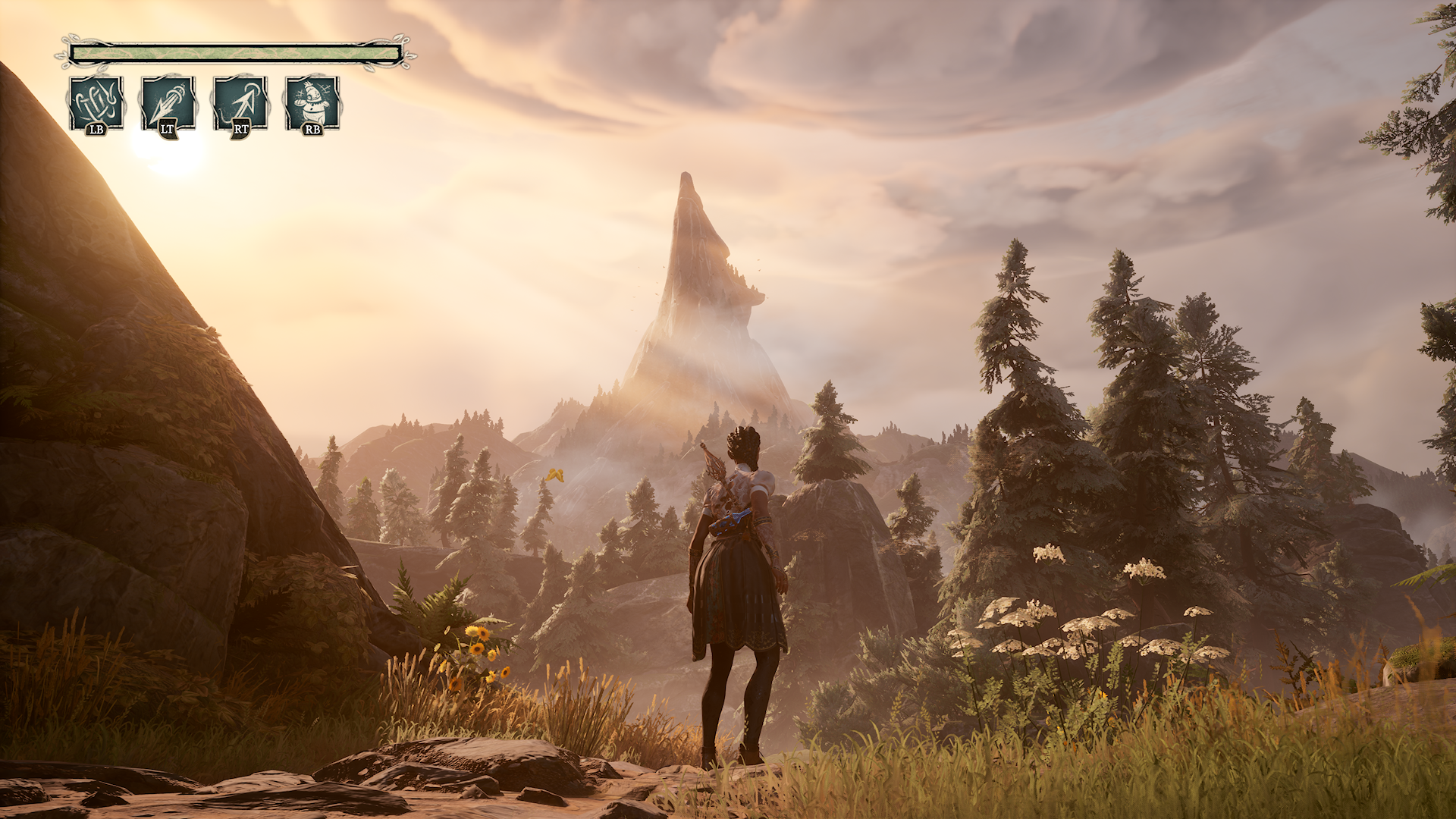 Gameplay screenshot from South of Midnight showing a player character standing in a vibrant, mountainous landscape at sunset. The character faces a towering, pointed mountain surrounded by dense trees, rocks, and lush vegetation. On-screen UI displays ability controls (LB, LT, RT, RB), emphasizing the game’s action-adventure mechanics and immersive Southern Gothic world design.