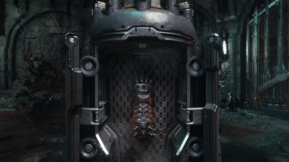 The image features a dark, metallic and cybernetic-looking device, shaped like a hand and spinal column, embedded in a metal wall. The device is affixed to a textured metal frame or chamber, accentuated with spots of red light emanating from within. The surrounding environment appears to be a dark and gritty, possibly medieval or gothic setting. The details evoke a sense of dystopian or sci-fi horror.